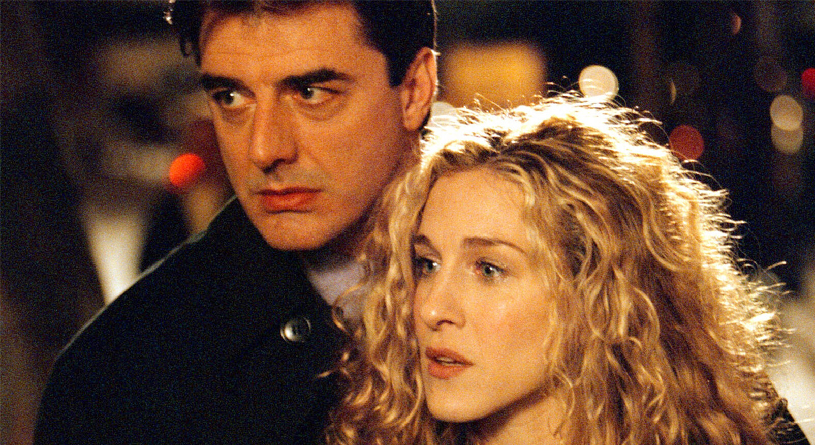 Carrie Bradshaw en Mr. Big koken samen in een keuken uit Sex and the City, ze malen peper en hebben een intiem moment.