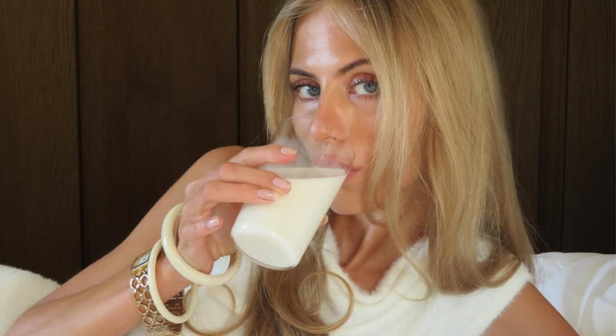 woman drinks a glass of milk