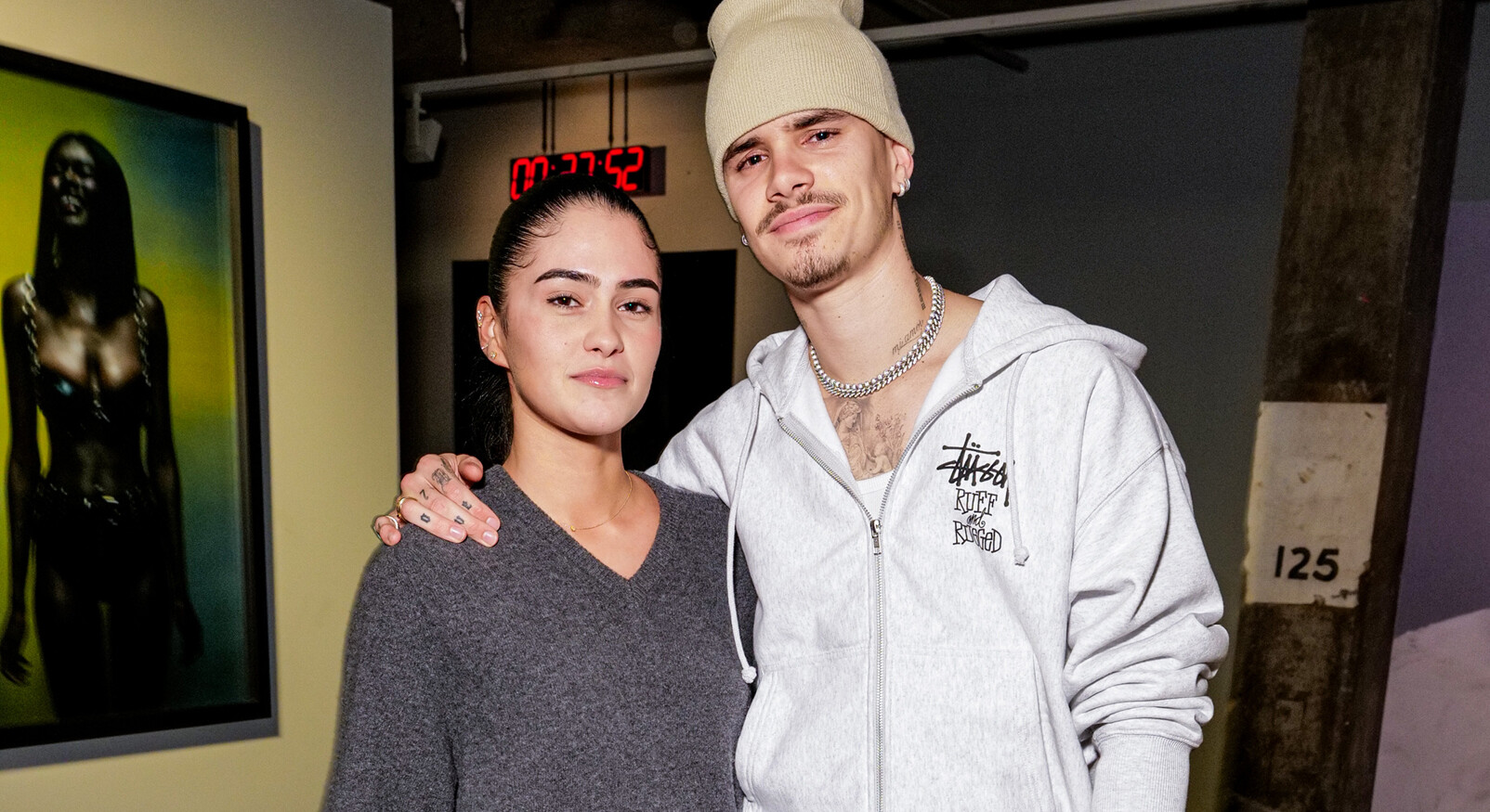 Romeo Beckham and Kim together in a photo Romeo with a large beige hat on his head and she in a gray sweater