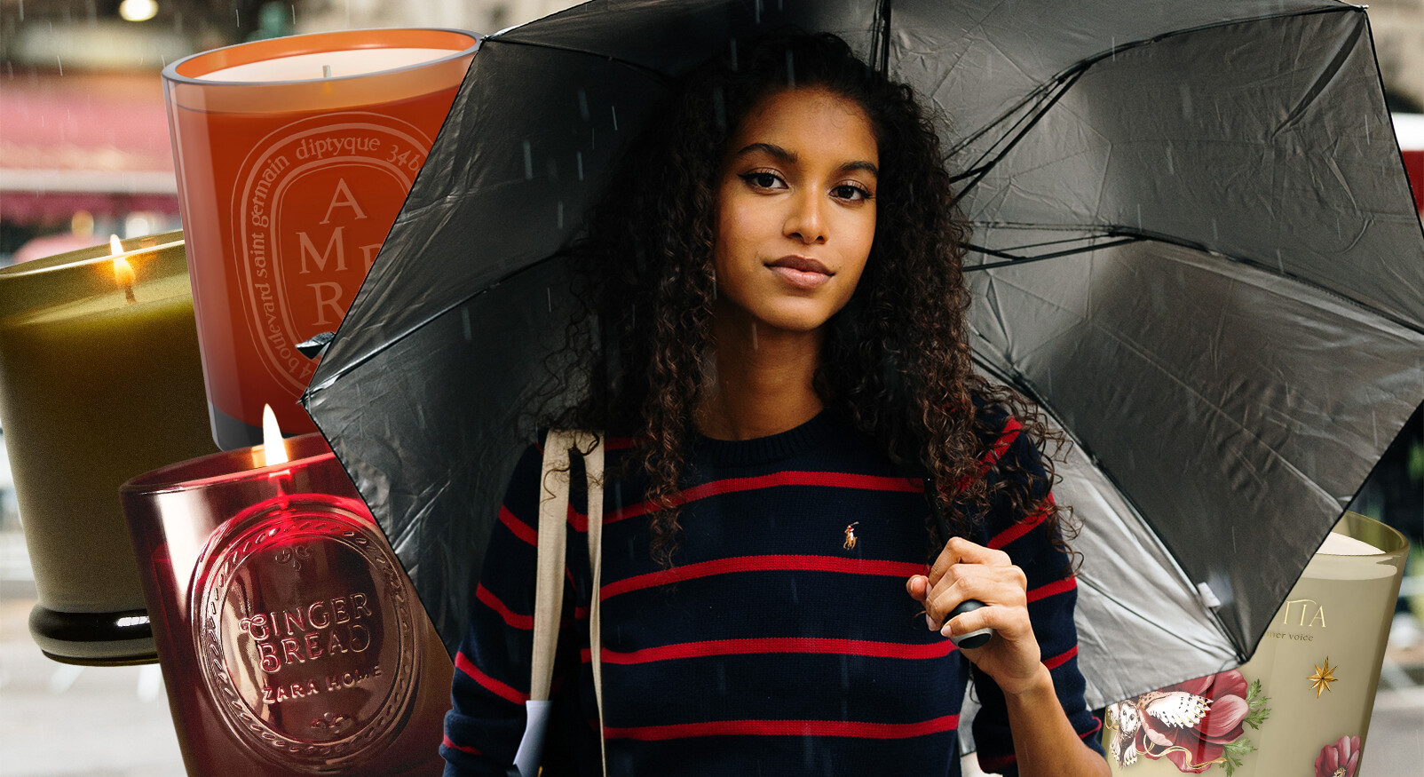 A young woman with dark curly hair and a striped jumper stands outside in the rain under an open black umbrella. She is looking directly into the camera. The image is a collage, showing in the background and around the woman several burning scented candles in glass jars, including one from Diptyque with 'AMBRE' on it and a red one from Zara Home with 'GINGERBREAD