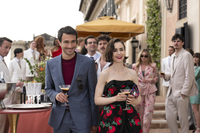 man and woman look at each other lovingly with a cocktail in hand