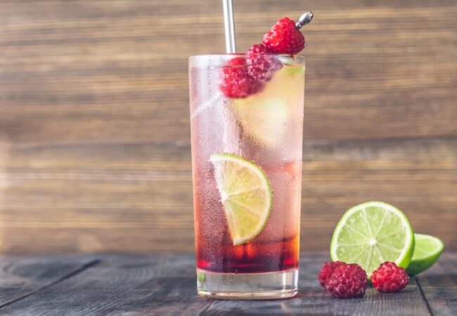 Glass of Raspberry lime rickey cocktail garnished with fresh berries
