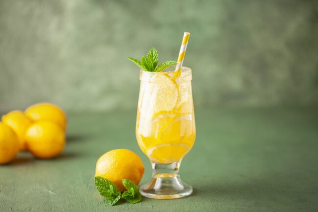 Homemade Limoncello spritz drink of liqueur, sparkling wine and lemon in cocktail glass
