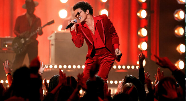 Bruno Mars performing in a red suit