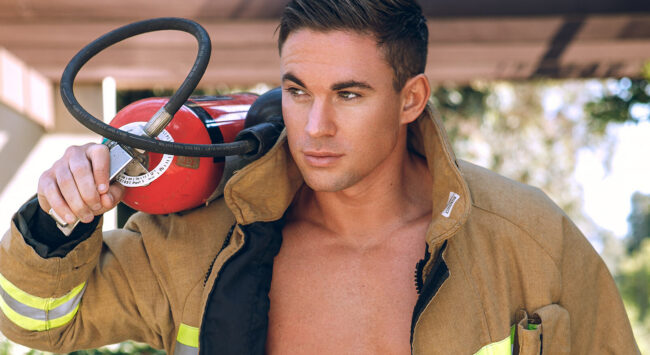 handsome firefighter with jacket open and six-pack