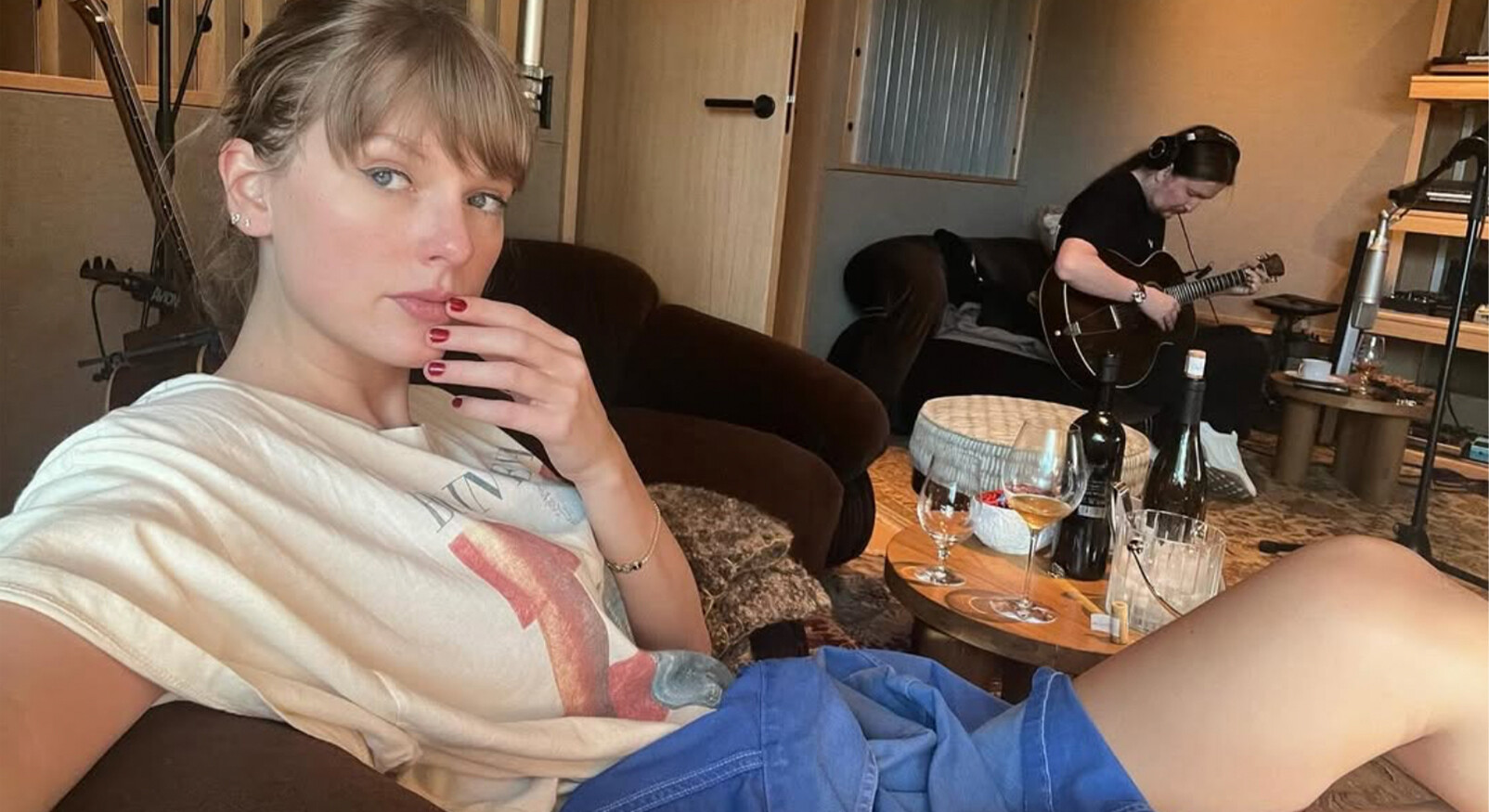 Taylor Swift takes a selfie with wine in the background