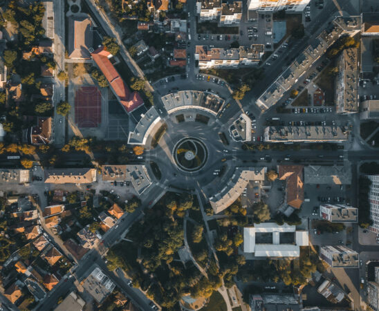 aerial photo, top view, roundabout, urban planning, buildings, road network, trees, shadows, urban landscape