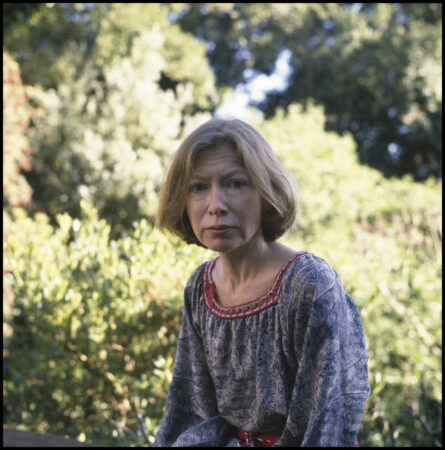 Portrait of American author Joan Didion as she poses outdoors, 