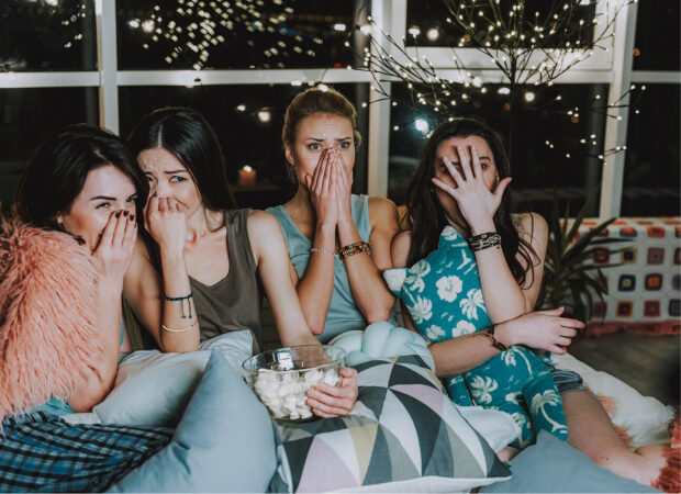 girls watching a horror film together