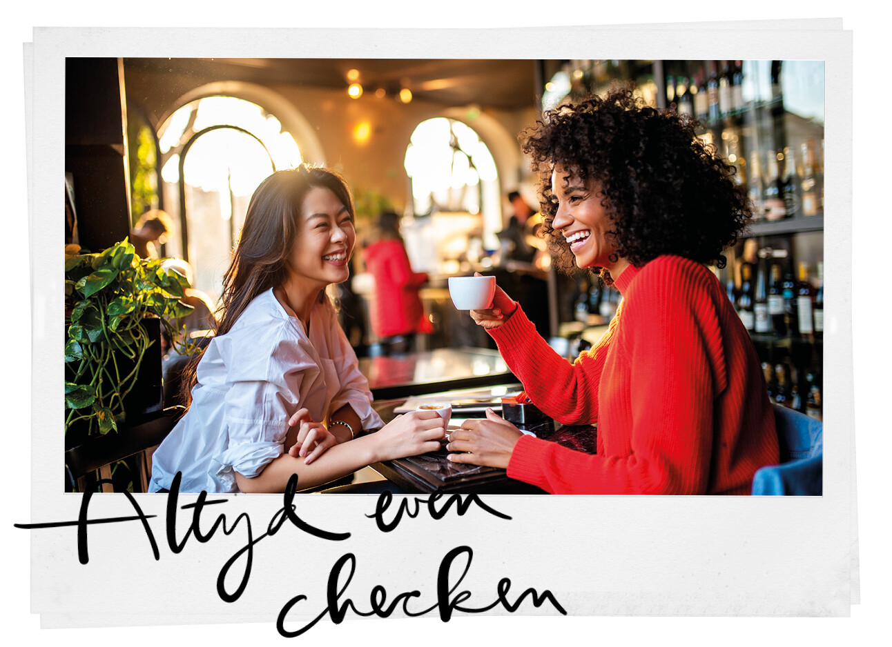twee vrouwen aan de koffie lachend in een restaurant praten